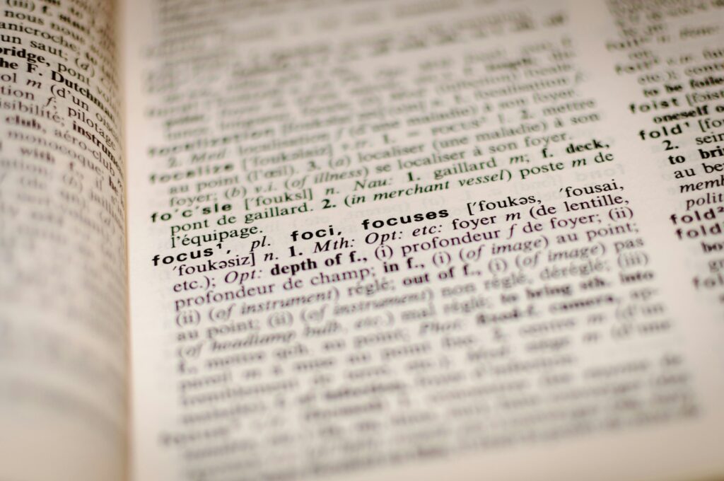 Close-up of a bilingual dictionary, representing the terminology research required for accurate human legal translation.